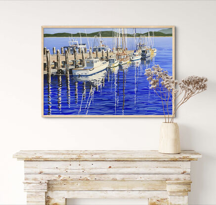 Sunny winter day, depicting fishing boats and yachts, and their reflections, tied up to a jetty.