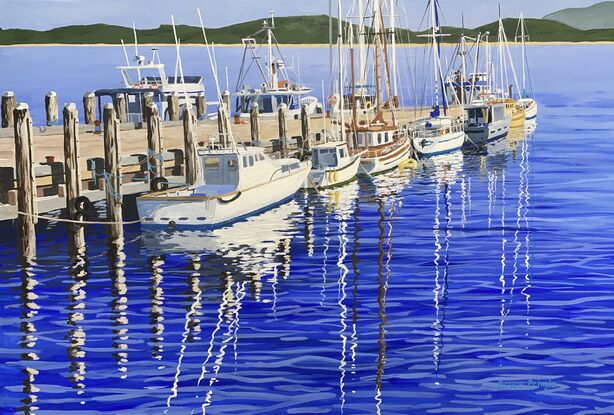 Sunny winter day, depicting fishing boats and yachts, and their reflections, tied up to a jetty.