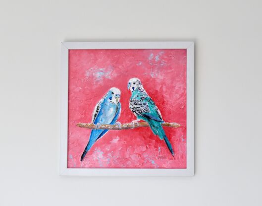 A thickly textured oil painting of a pair of blue and green budgerigar birds on a vibrant pink background. They are facing each other on a perch.