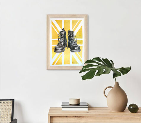 A graphite black and white drawing of two Doctor Martens boots. Behind the shoes is a gold metallic Union Jack. 