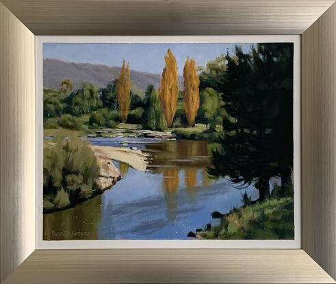 A fast flowing river with autumn colours.