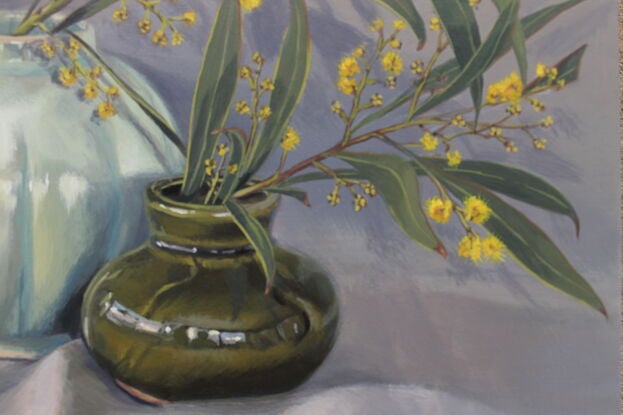 Yellow wattle in vintage green vases