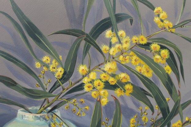 Yellow wattle in vintage green vases