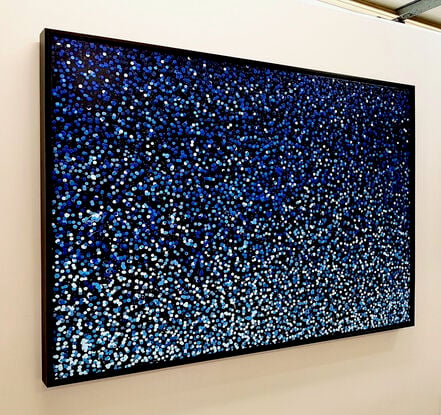 vibrant blue dots dropped onto black canvas