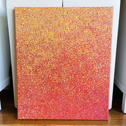 A red, orange, and yellow abstract dotted painting.