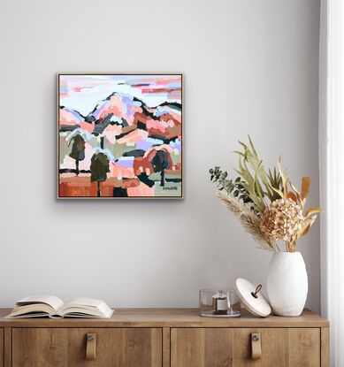 Mini sized framed canvas with a textured landscape scene in earthy tones, orange, green, brown and lilac abstract hills, trees and foliage shapes chunky paint with visible big brushstrokes.