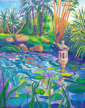 Colourful view of a lagoon with waterlilies and water feature with palms and bamboo in the background.