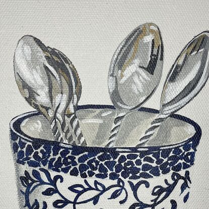 blue and white cup with silver spoons