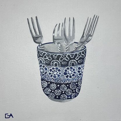 blue and white cup with silver forks