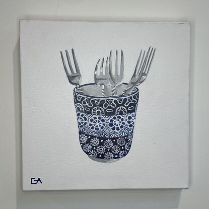 blue and white cup with silver forks