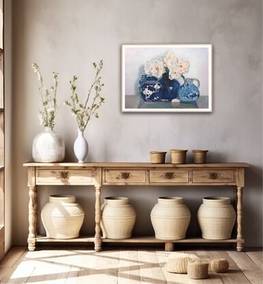 White iceberg roses in a blue and white ceramic vase, with other vases. 