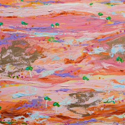 Pink and gold desert landscape with distant ranges in orange and an aerial type view of tiny green trees on a pink and pastel and gold embellished land. 