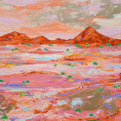 Pink and gold desert landscape with distant ranges in orange and an aerial type view of tiny green trees on a pink and pastel and gold embellished land. 