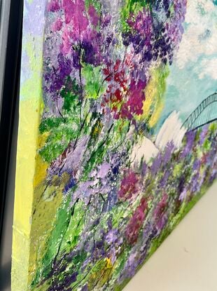 The painting depicts a mesmerizing landscape of botanic Australiana, showcasing colorful jacarandas in full bloom against a backdrop of Sydney Harbour Bridge and Opera House. The textured canvas brings the scene to life, capturing the intricate details of the florals and the iconic landmarks. The vibrant hues of the jacarandas contrast beautifully with the cloudy sky, creating a dreamy and enchanting atmosphere. This artwork effortlessly conveys the rich beauty and tranquility of nature intertwined with urban architecture, inviting viewers to immerse themselves in the serene charm of this picturesque setting.
Colours used cool yellow, light green, dark green, textured canvas , painted with a palette knife , black white mixed blues ‘
Comes with a certificate Of Authenticity 
Canvas is varnished for easy cleaning and ready to hang 