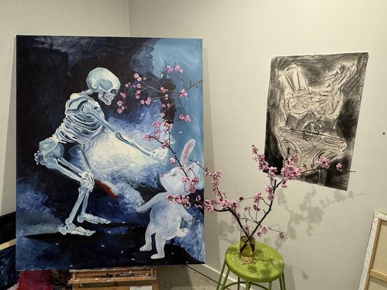 A young rabbit meets with a skeleton in a surreal landscape while a cherry blossom tree blooms over their heads. 