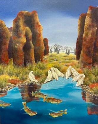 Barramundi swim in the waterhole while a flock of birds have gathered for a drink. A scene in the outback of Australia with overpowering red rocks in the foreground and boab trees at a distance.