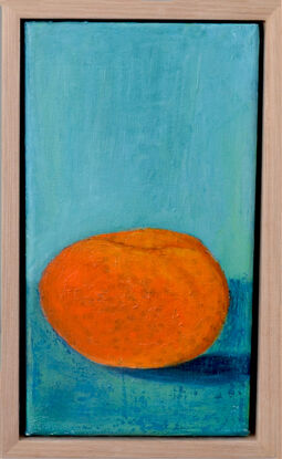 orange mandarine on turquoise bench