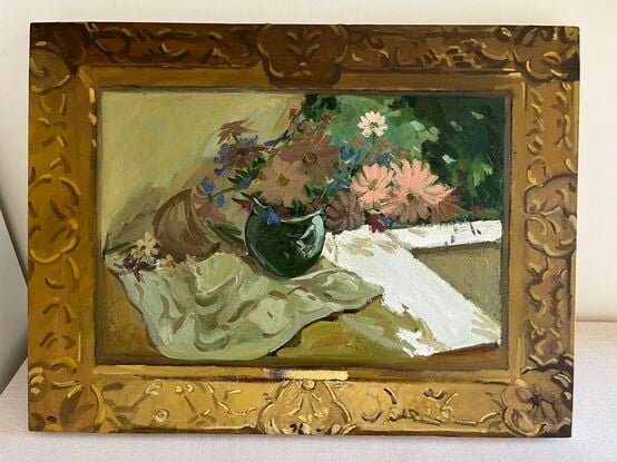 Pink and cream flowers in green vase