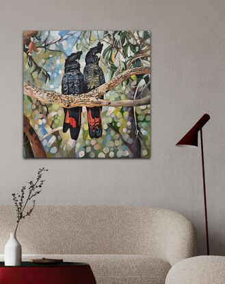 Black Cockatoos perched on a branch against speckled light background.