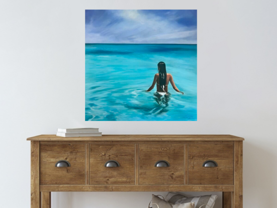 Woman standing in waist-high water looking to the distance. 