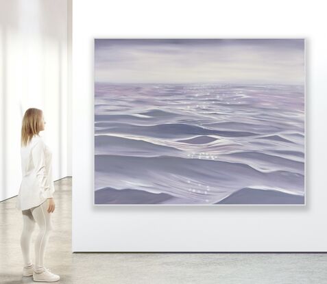 Gentle close up ripples and waves on an ocean surface in light purple and grey