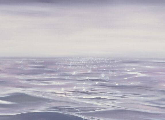 Gentle close up ripples and waves on an ocean surface in light purple and grey