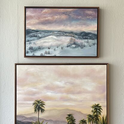 Loose landscape of snow on mountains with pink clouds in the sky 