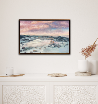 Loose landscape of snow on mountains with pink clouds in the sky 