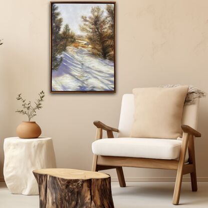 Landscape scene in the snow with pine trees either side, sun setting in the background and footprints in the snow 