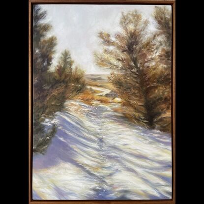 Landscape scene in the snow with pine trees either side, sun setting in the background and footprints in the snow 