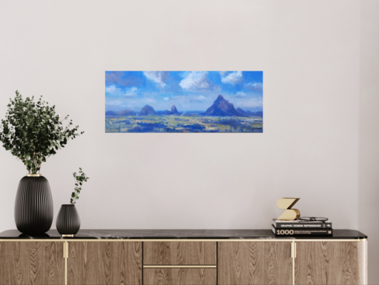 Blue sky, white clouds, blue mountains,distant farms, green trees