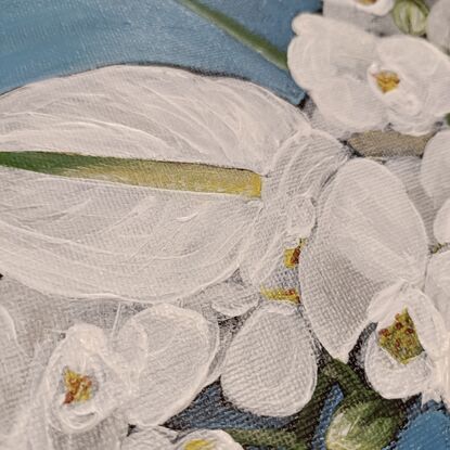 This painting features a vibrant still life of white orchids is set off against a rich blue background. The central focus is a collection of white orchids, their delicate petals contrasting beautifully with the darker hue. A few white Anthurium flowers add a touch of drama with their unique shape. The flowers are arranged in a simple, earthenware vase, further emphasizing their natural beauty. The overall composition is balanced and harmonious, creating a sense of tranquility and elegance.