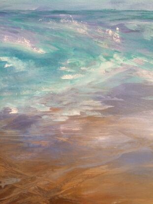 Ocean waves criss-crossing with blue sky and white clouds and sandy beach.