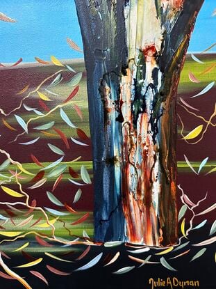 Several colourful gum tree trunks, a Kookaburra sitting in the tree with some leaf litter and twigs a lovely deep maroon with pops of green fading light blue upward to a bright blue sky 