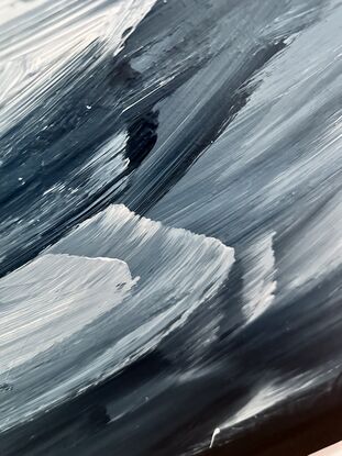 Black, white and grey large brushstrokes which are a mixture of thick and bold with blended edges