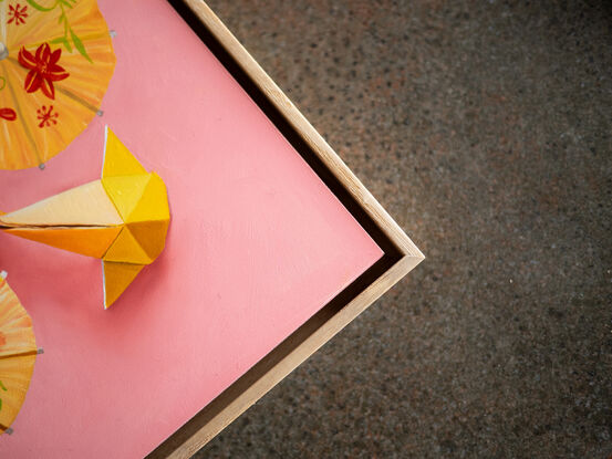 Two origami koi on a golden yellow background.