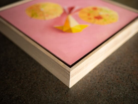 Two origami koi on a golden yellow background.