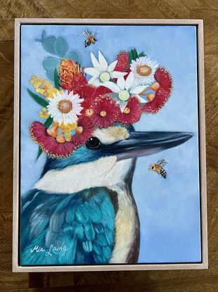 Sacred kingfisher bird with a crown of wildflowers. 