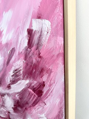 Large brushstrokes in pink, white and magenta framed in sustainable timber