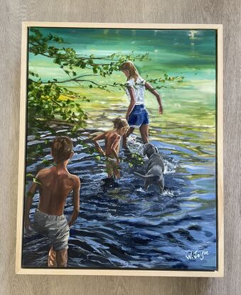 A boy and a girl together with mum  and the dog explore the waters of a river bank. Light filters through the surrounding trees  and highlights the figures and the moving water. Floating frame in pine, ready to hang.