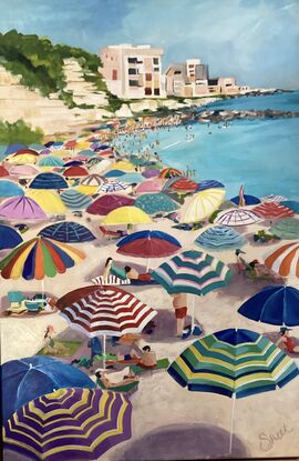 A beach scene full of bright fun beach umbrella's. 