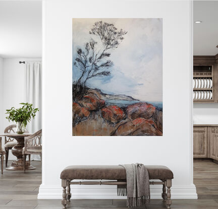 A seascape of the the Bay Of Fires in Tasmania with a tree and clouds