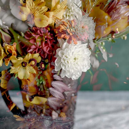 Floral bouquet with vintage glass vase.