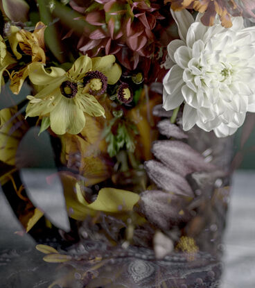 Floral bouquet with vintage glass vase.