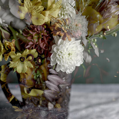 Floral bouquet with vintage glass vase.