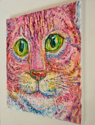 Portrait of the face of a pink cat with yellow eyes.