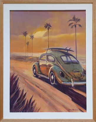 Classic VW Beetle drives towards the sunset