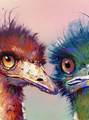 Two emus painted in reds and green and blue. 