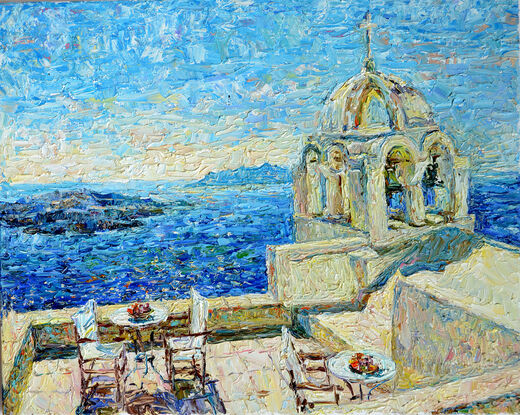 The blue Aegean Sea against the background of a snow-white building with a domed roof, in the middle with a table, chairs and fruit.