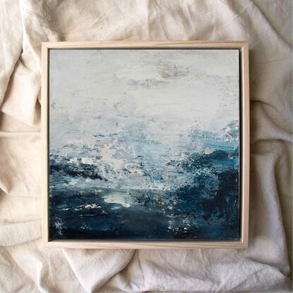 An ocean inspired textured small original painting in a moody predominantly deep blue and off white palette with a hint of silver